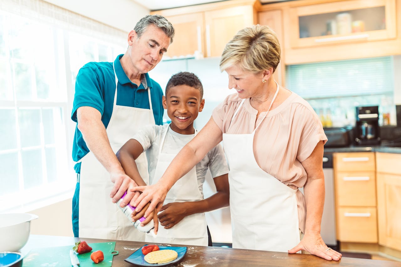 A diverse family enjoys a baking activity in their cozy kitchen, highlighting love and togetherness.